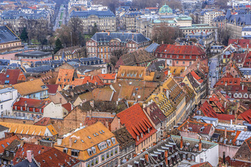 Naklejka na ściany i meble Aerial view of Strasbourg old city with red roof tiles. France. Strasbourg is the capital and principal city of Alsace region in eastern France and is official seat of European Parliament.