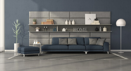 Modern living room with sofa in front of a leather panel with shelves
