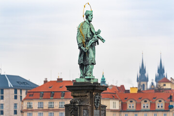 Prague, Czech Republic-February 02, 2019. Statue of saint John of Nepomuk the oldest on the north side of the famous Charles bridge, said to bring good luck to those who touch it.