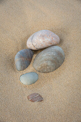 Fototapeta na wymiar Cluster of Pebbles on Sand