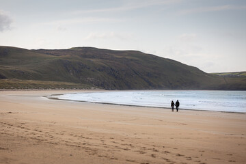 Fototapeta na wymiar Romantic Stroll on Tramore Beach sand County Donegal Ireland