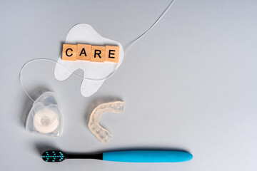 Dental care accessories: mouth guard, toothbrush, dental floss, dental concept on blue background