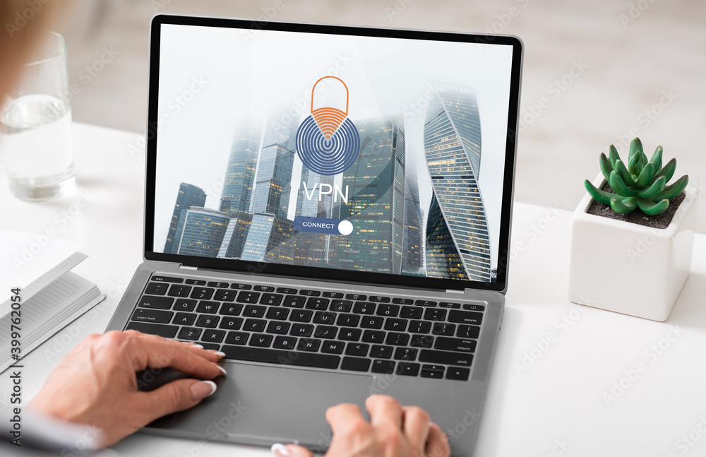 Poster businesswoman using laptop computer with vpn virtual private network connection at office