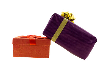 long lilac giftbox with a gold ribbon stands on an orange box on an isolated background
