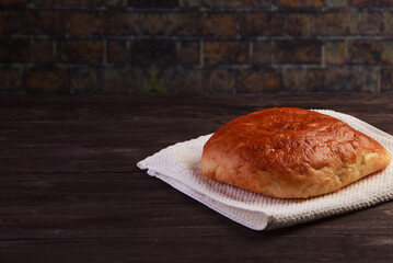 homemade loaf of bread on black wood background