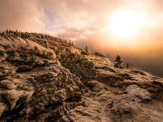Harsh landscape on a mountain range of Jeseniky mountains with stunted trees covered with rime in late autumn. Clouds and sunlight,daylight. Jeseniky mountains,Czech Republic.  .