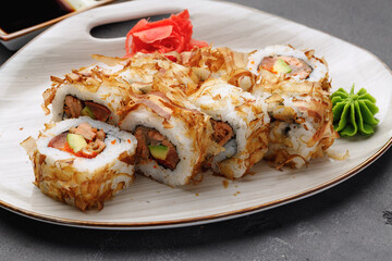 Sushi roll with tuna shavings on plate close up