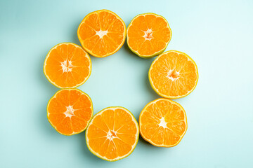 top view fresh tangerine slices lined on light-blue desk color orange photo juice fruit citrus