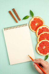 top view tasty fresh grapefruits with notepad on light-blue background health fruit diet fresh juice color