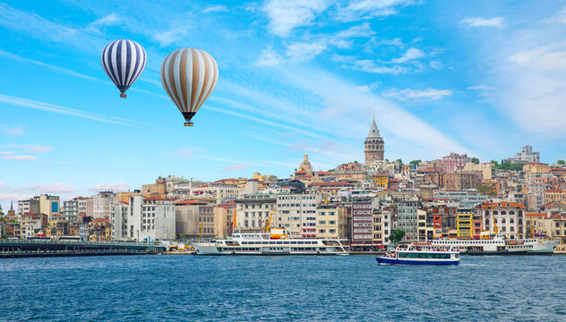 Hot air balloon flying over Galata tower - istanbul, Turkey