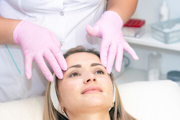 Obraz na płótnie Canvas Cosmetological facial massage.
