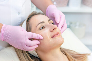 Naklejka premium Cosmetological facial massage.