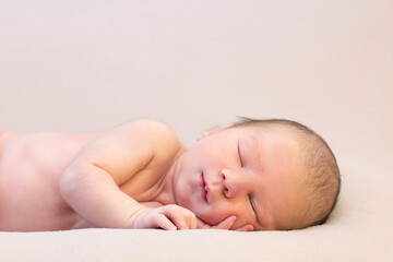 newborn baby lies in the bed