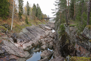 View of the rocky riverbed and the bridge. A landmark of the town of Imatra, Finland.
