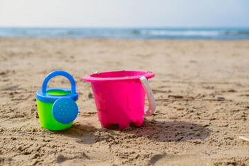 Fototapeta na wymiar Beach toys for children. Buckets in the sand on a sunny day