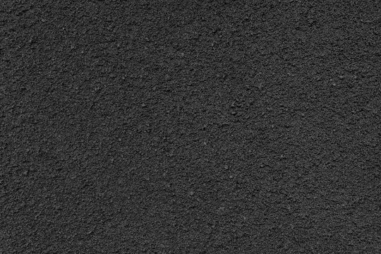 Black paper background texture. High resolution photo.