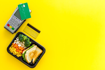Food delivery payment with terminal and lunch boxes with meal