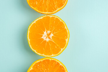 top view fresh tangerine slices lined on the light-blue background color orange photo juice fruit citrus