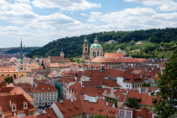 Fototapeta na wymiar Prague city panorama. Orange and red roofs of the old city.