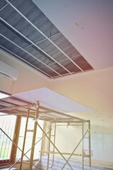 Obraz premium Inside the steel room, the scaffold is installed with an open space ceiling. Outside lighting, sunlight, classroom, work, interior