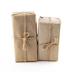 brown giftbox wrapped in kraft paper, the package is standing upright on an isolated background