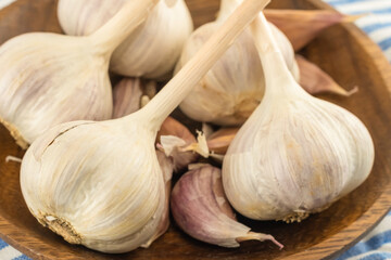 heads of white garlic close-up on a wooden background