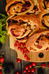 Berry yeast dough pie for tea. Sweet pastries with berry jam. Blackberries, strawberries and currants in dessert. Handmade cake