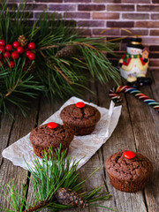 Delicious chocolate muffins on the New Year's table. Good New Year spirit. Holidays New Year and Christmas.