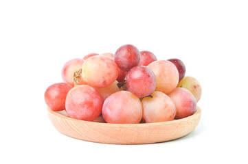 Bunch of fresh grape on wooden plate isolated on a white background.