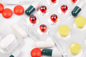 Different medicines tablets, pills in blister pack, medications drugs, macro close up in a white...
