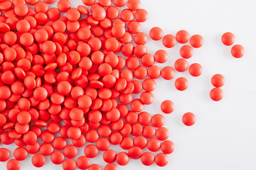 Background of red round tablets pills, macro close up