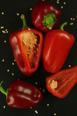 Red peppers on black background