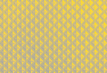 Illuminating and Ultimate Gray color of the year 2021. Vintage background with small symmetrical gray and yellow rhombus.