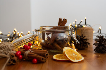 Glass jar with cinnamon sticks inside, with many christmas rustic style, handmade diy ornaments,...