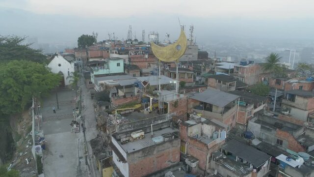Aerial approaching artist's golden moon structure on the top of the Providencia favela in Rio de Janeiro, Brazil