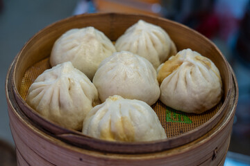 Traditional Chinese steamed bun in tray, Dumping chinese food or dim sum for sell in Chinatown market, Singapore