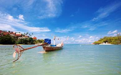 Tropical beach with boat at sea in Thailand