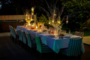 Served festive table with candles in the evening