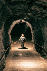 person walking down the stairs in a tunnel