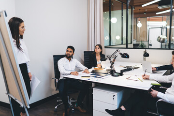 Serious boss explaining strategy to coworkers