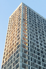 Fototapeta na wymiar cement base of an apartment building condominium building a house against the sky vertical photo