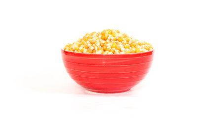 A bowl of corn kernels on a white background.