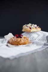 
Sweet pastries with berries on a light background.