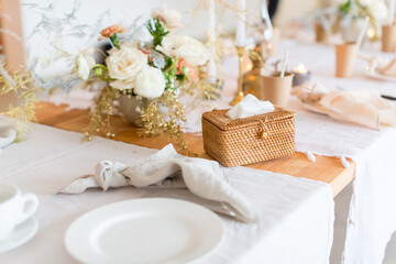 Christmas decoration of the festive table with cakes, glasses and candles