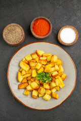 top view tasty fried potatoes inside plate with seasonings on dark background photo food oil color bread