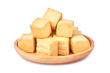 close-up of a pile of diced fish tofu in wooden plate isolated white background with clipping path