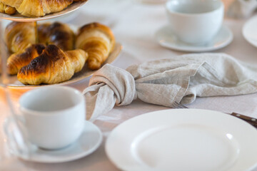 Christmas decoration of the festive table with cakes, glasses and candles