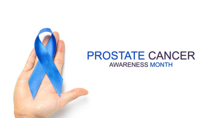 Cancer awareness blue. Blue ribbon in hands isolated on white background. Awareness prostate cancer...