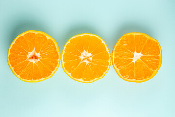 top view fresh tangerine slices lined on light-blue background color orange photo juice fruit citrus