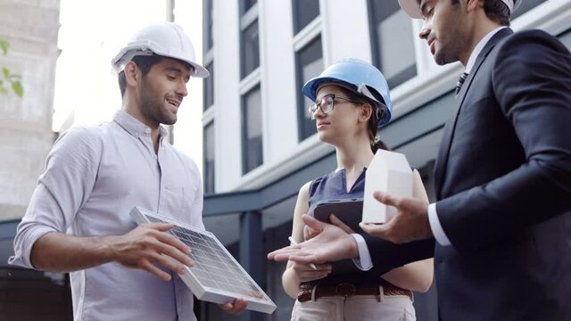 Group Electrical Engineer Technician Talk to business people to invest in solar cells outside building or industrial factory. Collaboration on energy reduce for environment. Natural energy technology